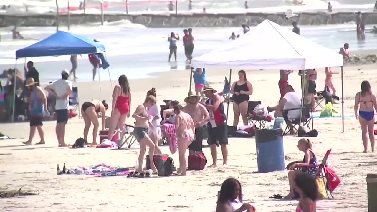 Americans soak up sun on beaches as coronavirus death toll nears 100,000