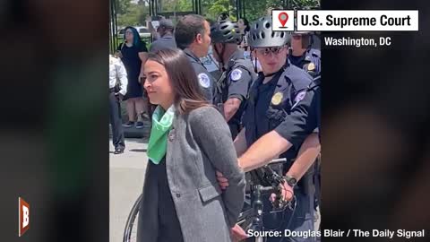 Conflicting Virtue Signals: AOC Pretends She's Handcuffed... Until She Raises a Fist