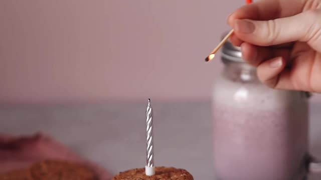 Person Lighting a Candle