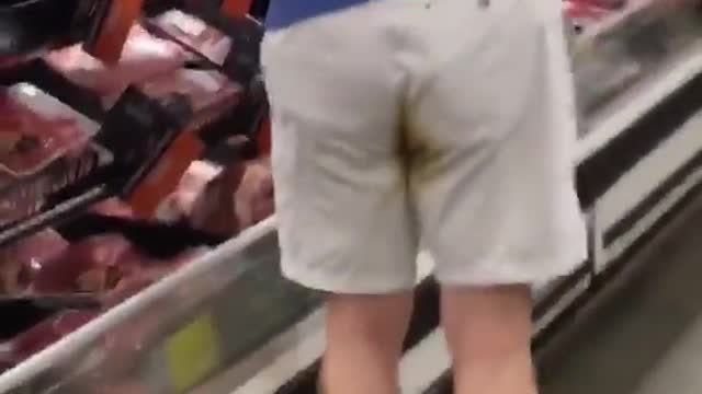 Man with stain on shorts