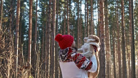 Man with dog of breed husky in winter on the snow