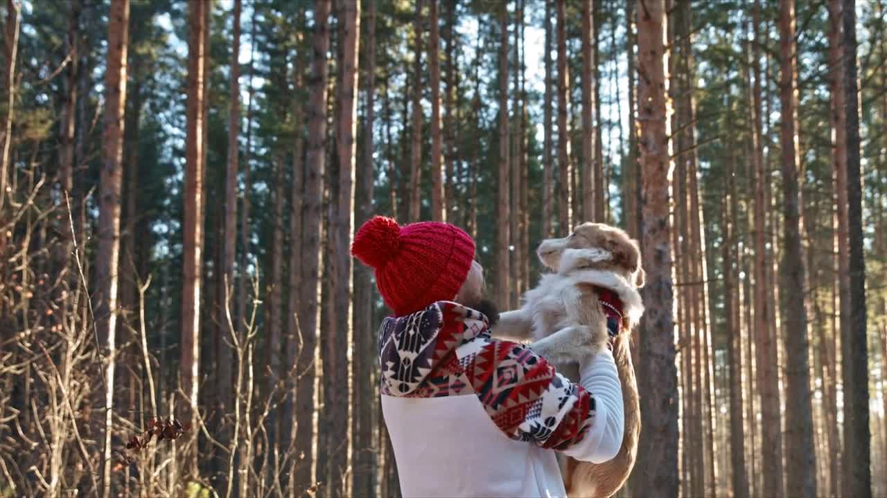 Man with dog of breed husky in winter on the snow