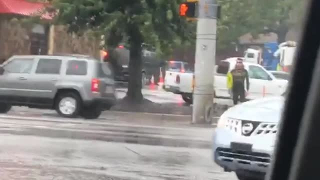 Music guy holding surf board waiting to cross street