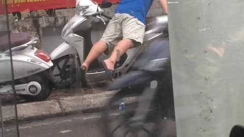 Man Rides Motorcycle in Unusual Way