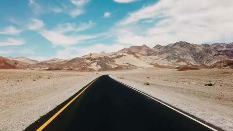 Footage of traveling a road built on a desert