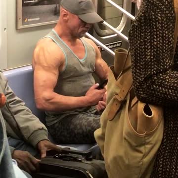 Man grey shirt taking pictures of himself flexing