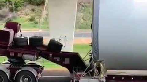 A car with goods at the limit of the height of the bridge