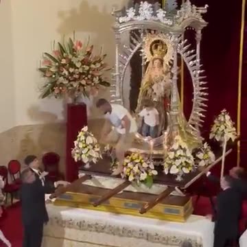 Man runs to church with the child on his shoulder and leaves him on the statue of the Madonna