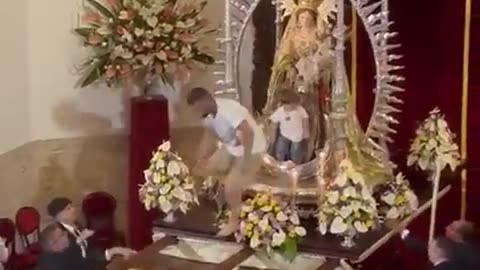 Man runs to church with the child on his shoulder and leaves him on the statue of the Madonna