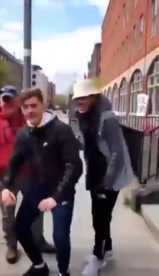 Migrant men shout "F*ck Irlanda" outside the International Protection Office in