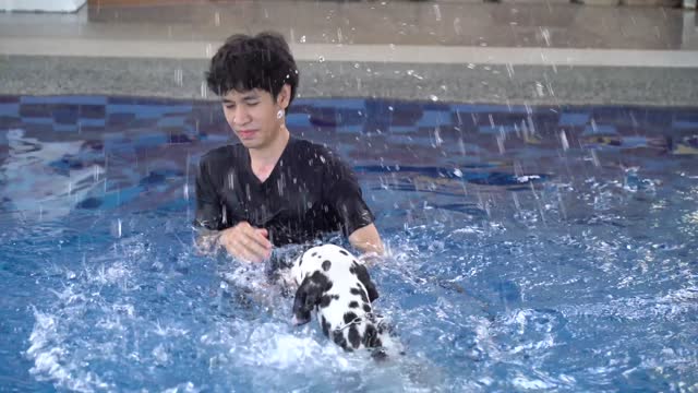 Man and a Dog Swimming Together