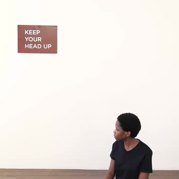 A Woman Looking at a Sign while Sitting on the Floor