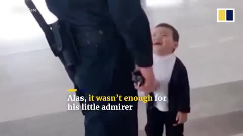 Adorable kid admires a security guard and asking him for a hug