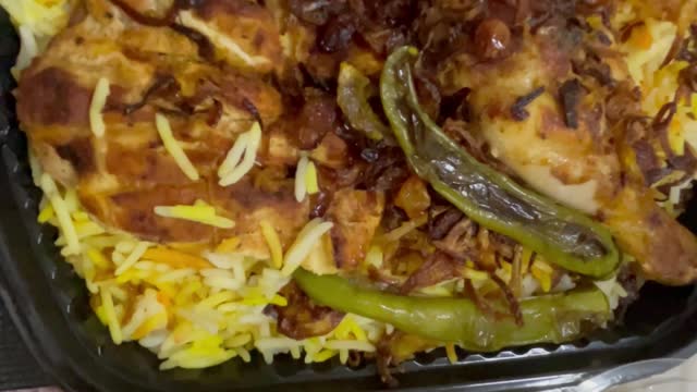 Kabsa rice with vegetables and chicken on plate