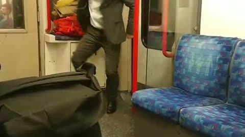 Suit man dances with white headphones in subway