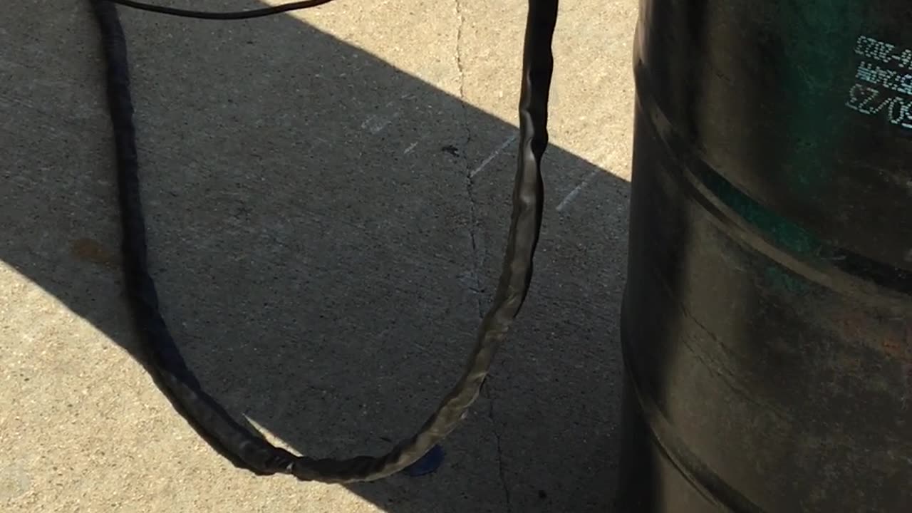 grandson helping grandpa make burn barrel intake holes with plasma cutter