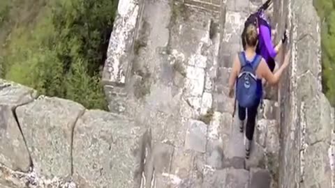 Two bricklayers demolish the great wall of china with an excavator