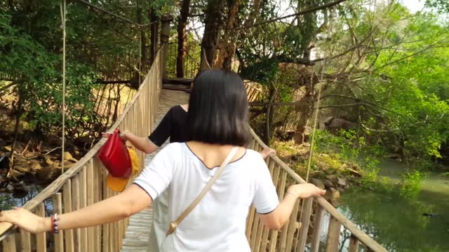 bamboo bridge is shaking and rough, it's hard to go ...