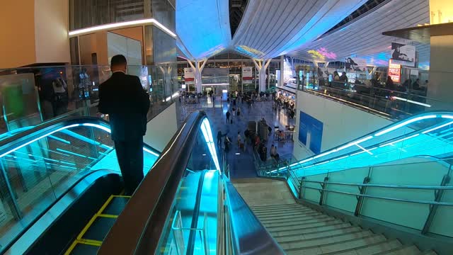 People In A Shopping Center In Time Lapse Mode.