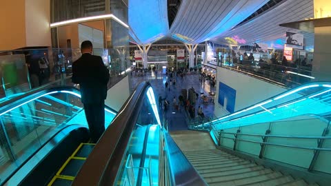 People In A Shopping Center In Time Lapse Mode.