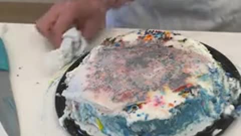 When he lifts the iron off the cake, it looks incredible!