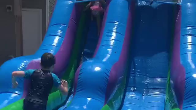 Grandma slides down waterslide