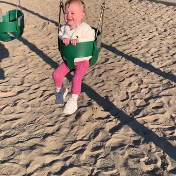 Toddler thinks kicking mommy on the swing is so funny!