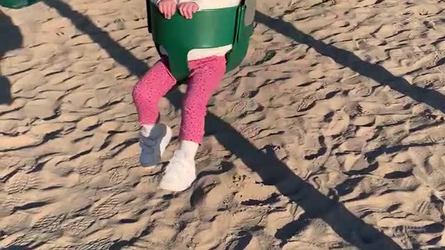 Toddler thinks kicking mommy on the swing is so funny!