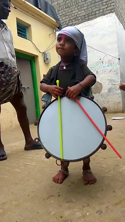 Cute boy playing with drums