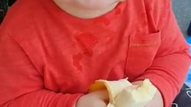 Small Baby eating banana