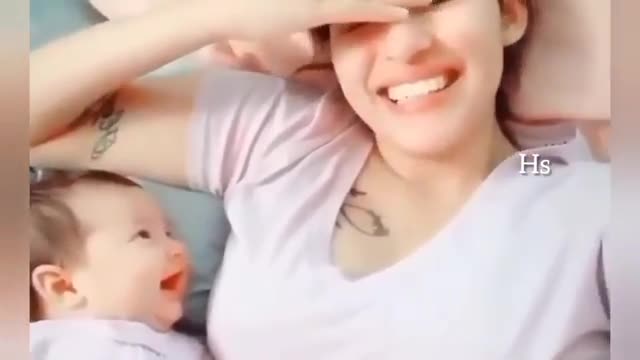 Adorable baby looking at her moom cutely