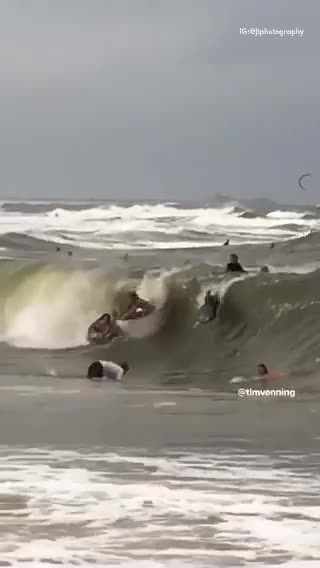 Bunch of surfers run into each other in barrel of wave