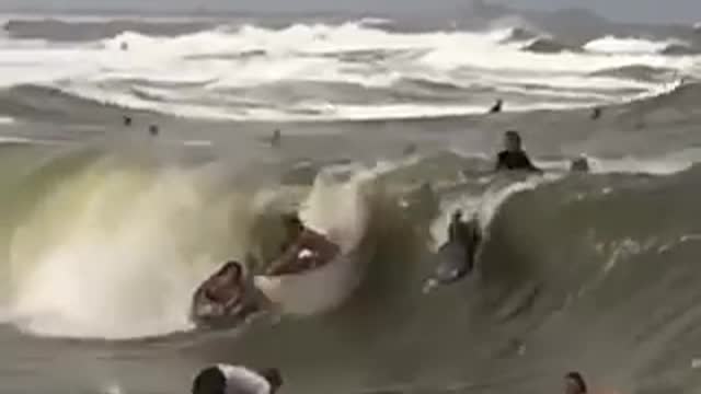 Bunch of surfers run into each other in barrel of wave