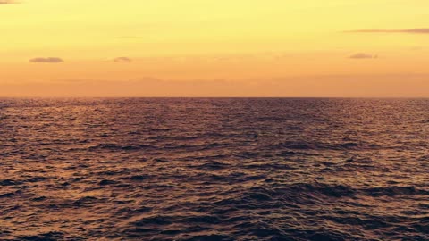 Reflection of sunrise on ocean waters on the horizon