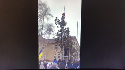 The civil people lowering the Russian flag , Ukraine