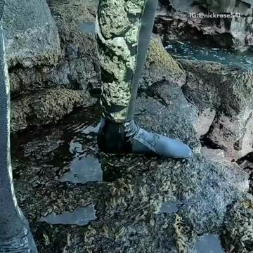 Man in camouflage wet suit pees himself