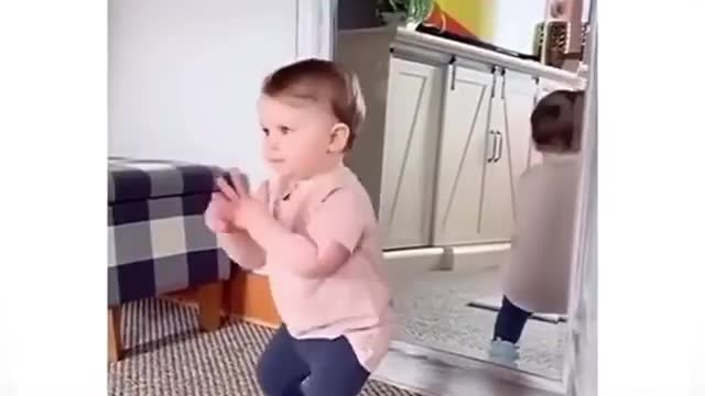 Cute baby funny dance in front mirror