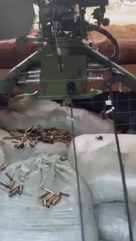 Ukrainian soldier remote operating a machine gun with a Steam Deck gaming system