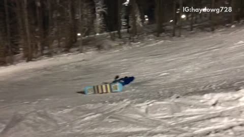 Guy blue jacket snow board land on head