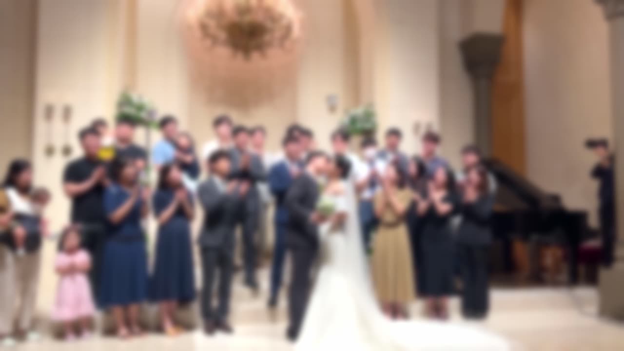 The bride and groom posing with acquaintances at the wedding