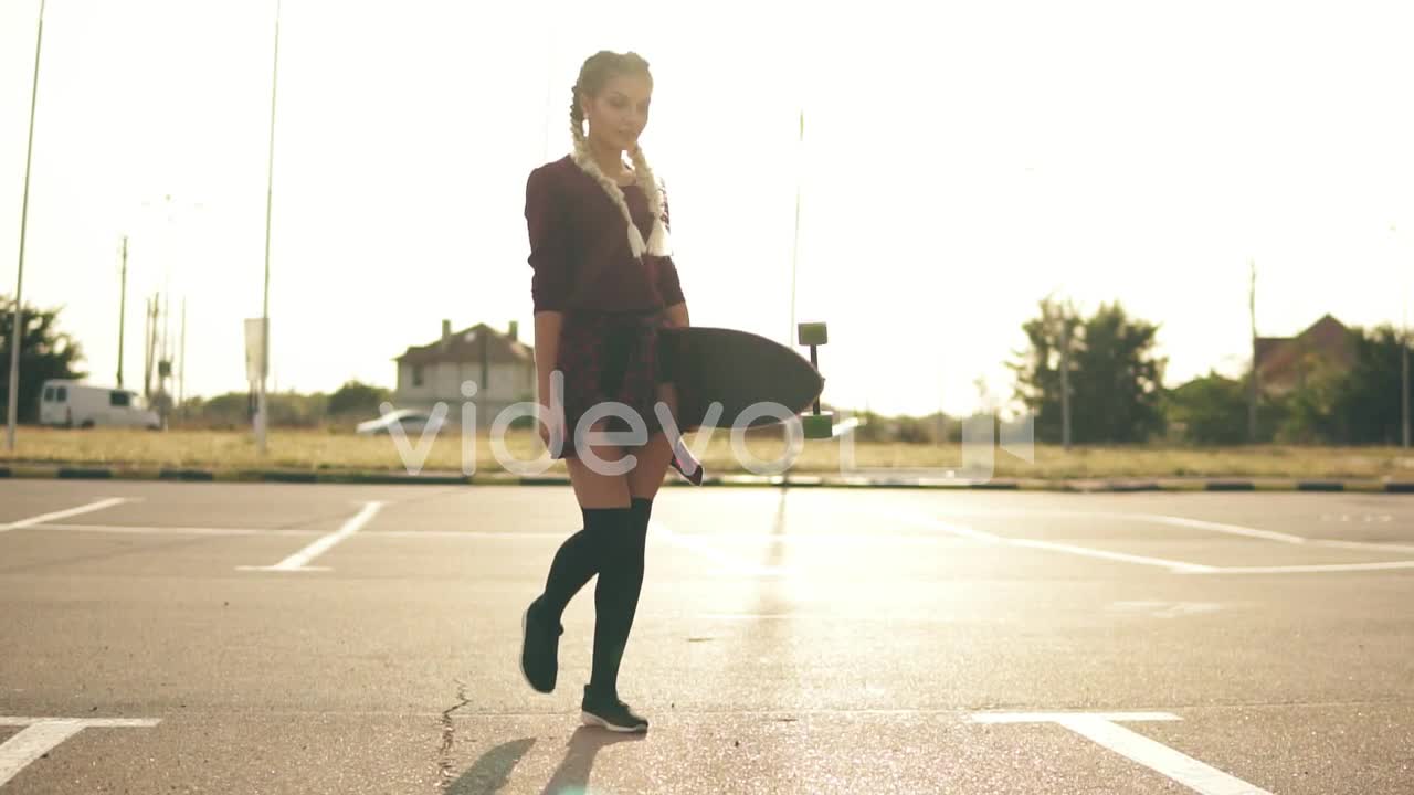 Young Happy Hipster Girl Is Walking In The Parking Smiling And Looking In The Camera During The Suns