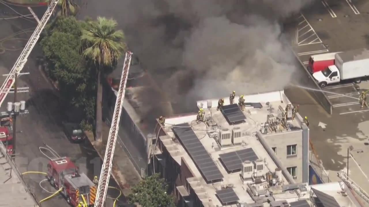 LAFD on scene single story commercial building, heavy fire and explosions as first engines arrived