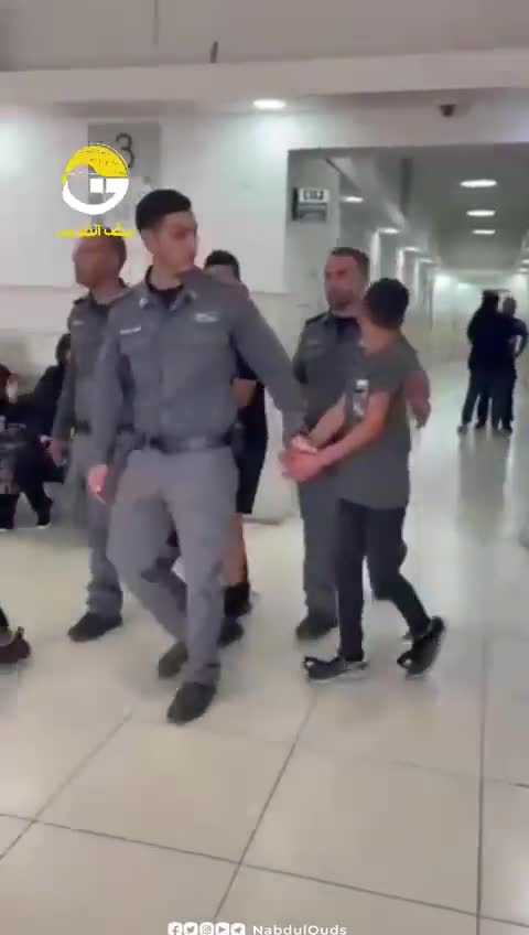 A Palestinian boy asks his family for a jacket as the Israeli forces take him