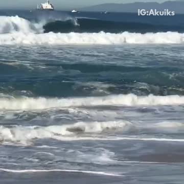 Old shirtless man hit by waves tumbles