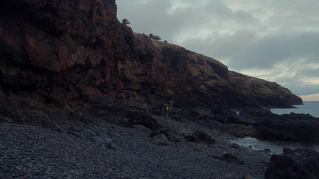 Friends exploring a rocky beach