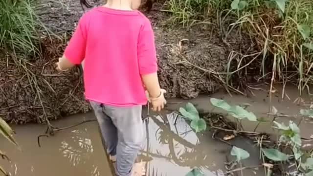 Baby crosses dangerous ditch