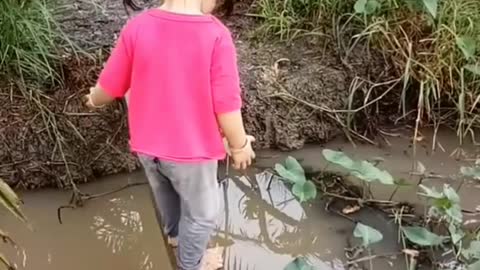 Baby crosses dangerous ditch