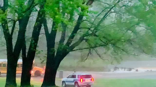 Police Officer Guides Bus to Safety in Flash Flood