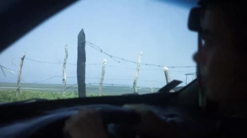 Woman in her car looking at the beach