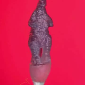 Carving a single grain of rice into a sculpture